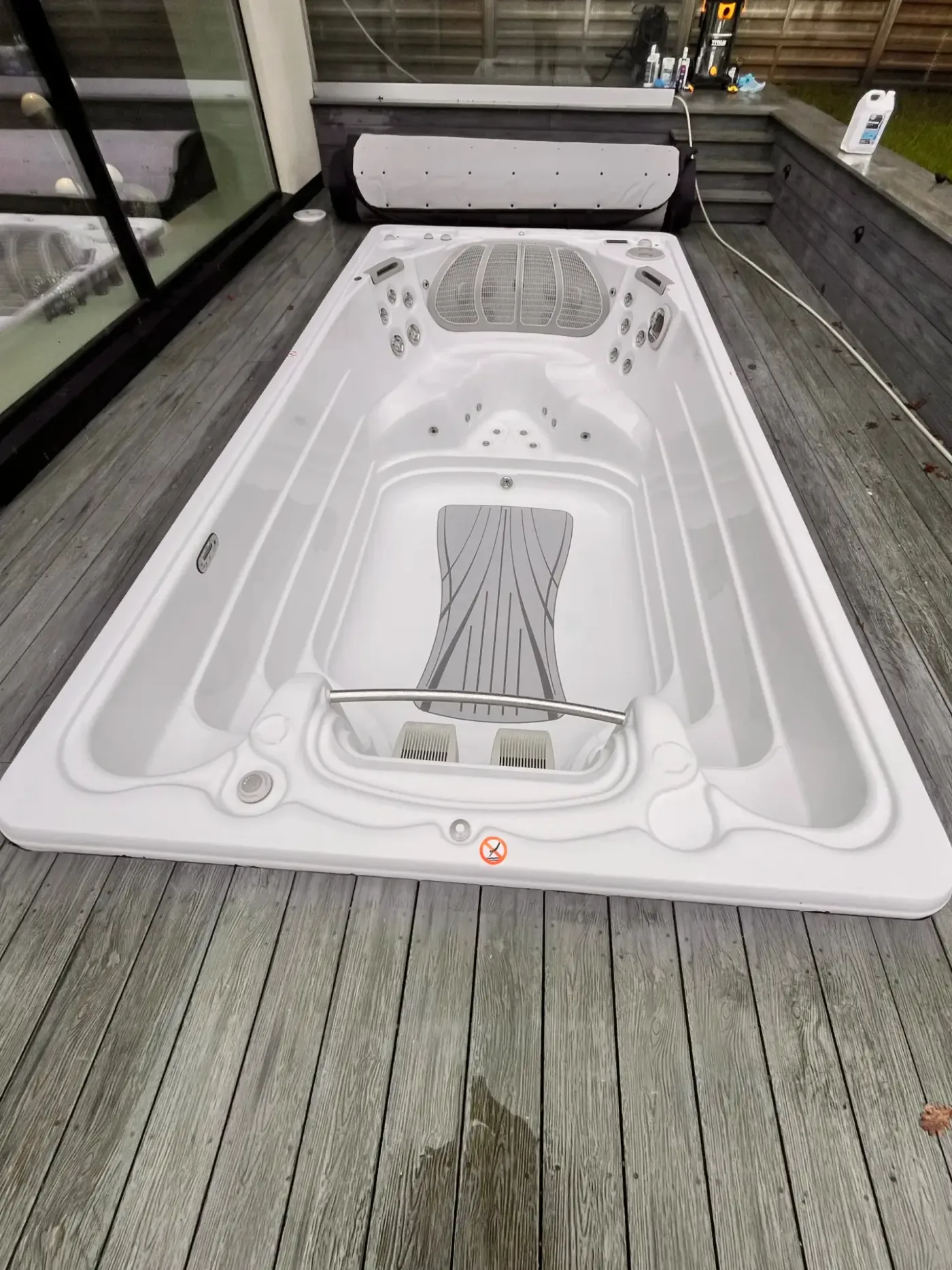 Elongated spa on a wooden deck