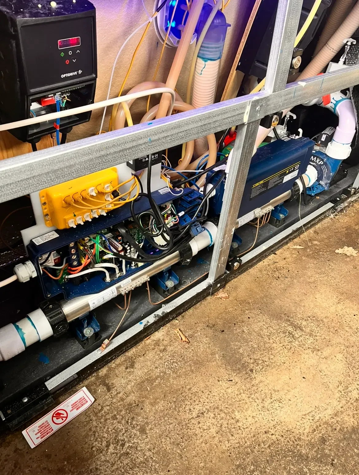 Open spa equipment cabinet with pumps and pipework